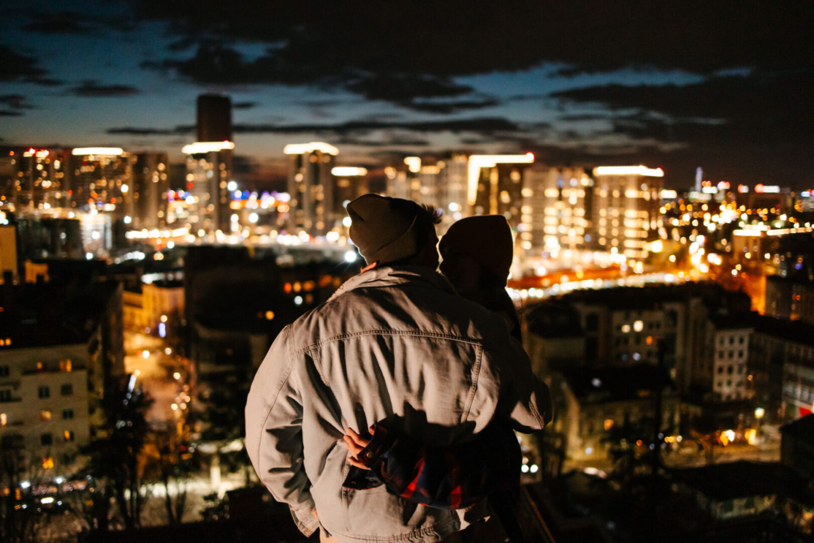 Couple admiring city lights at night