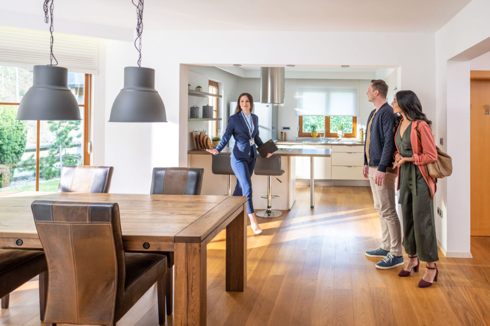 Realtor showing couple a modern kitchen