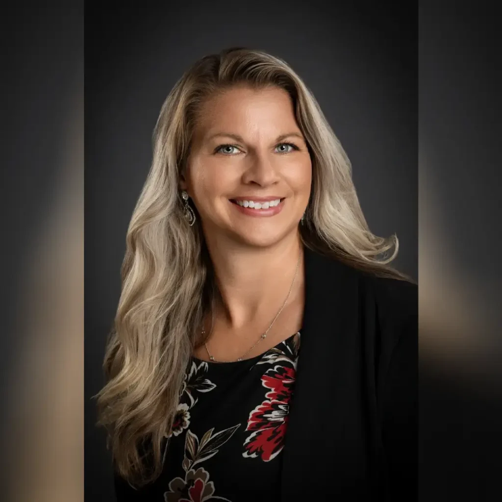 Professional portrait of smiling woman with blonde hair