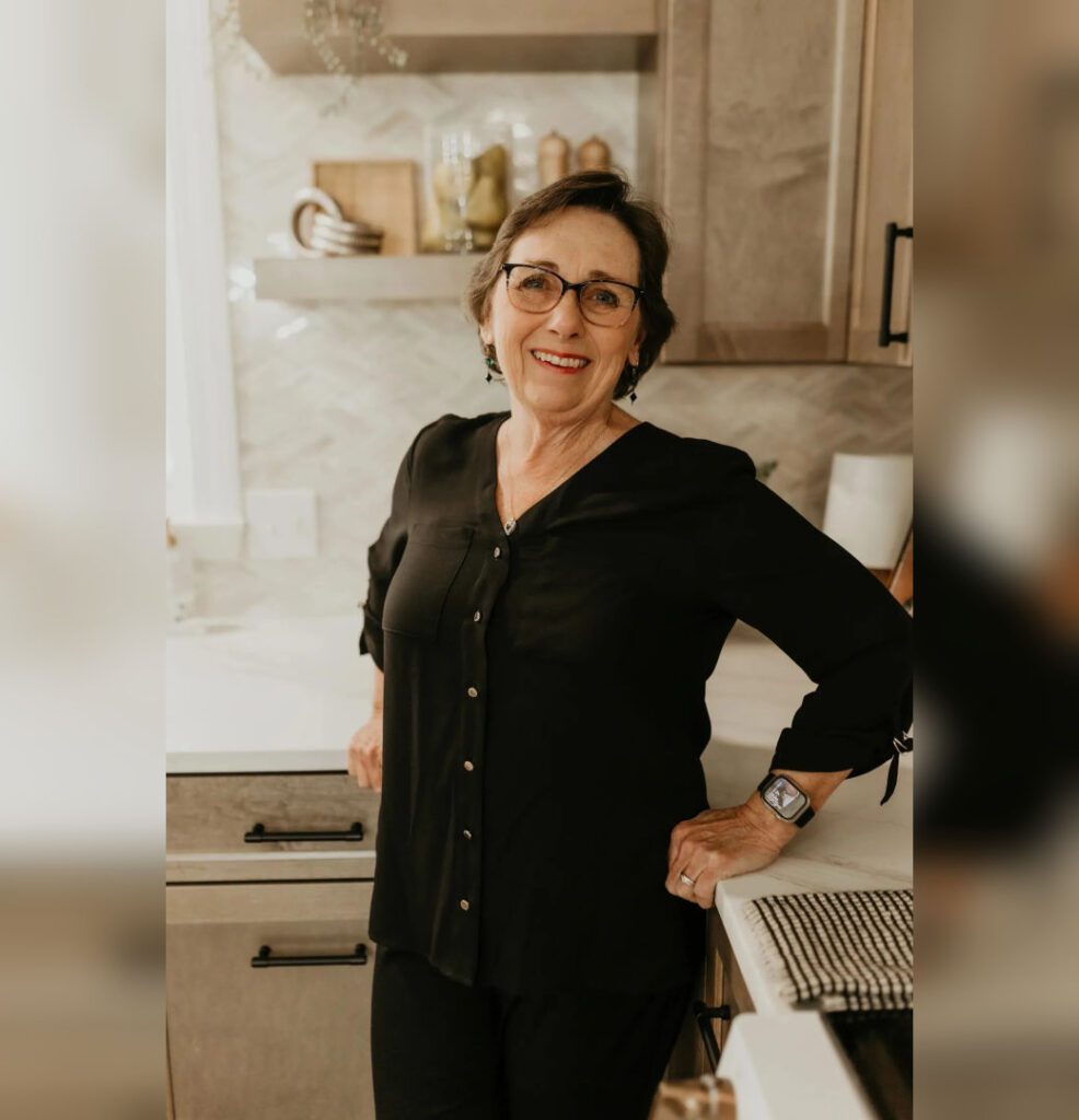 Smiling older woman standing in kitchen
