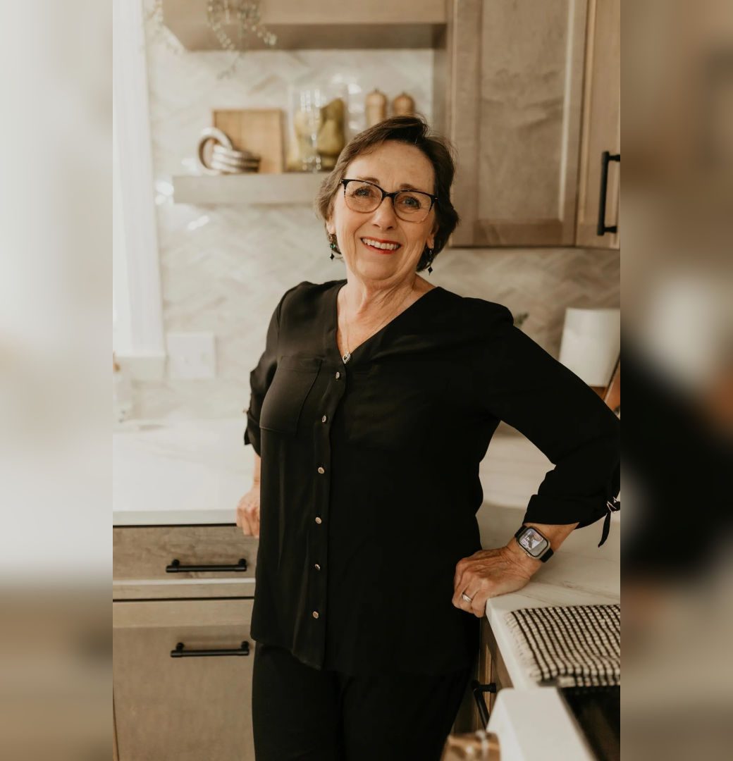 Smiling older woman standing in kitchen
