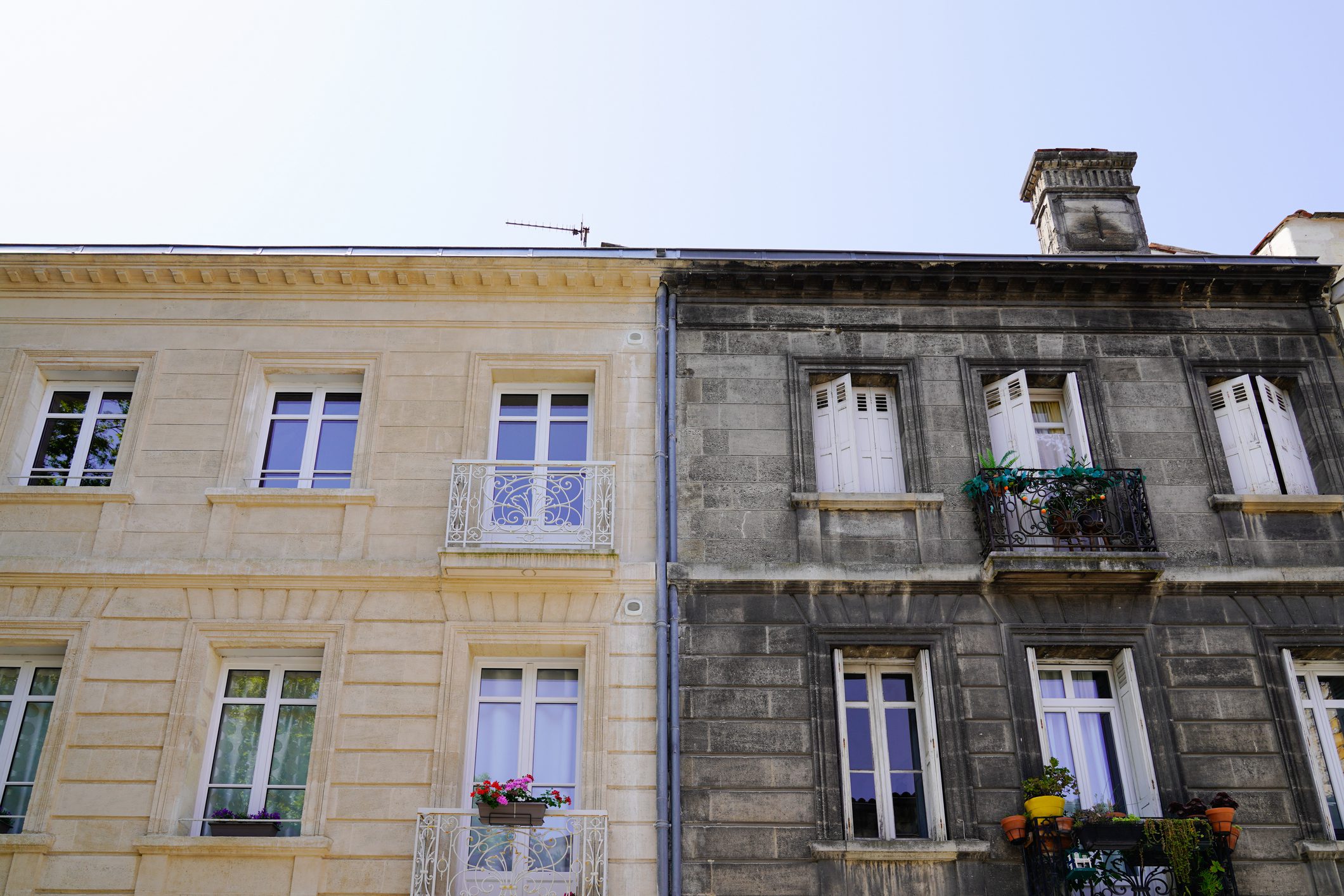 Two contrasting apartment facades with balconies