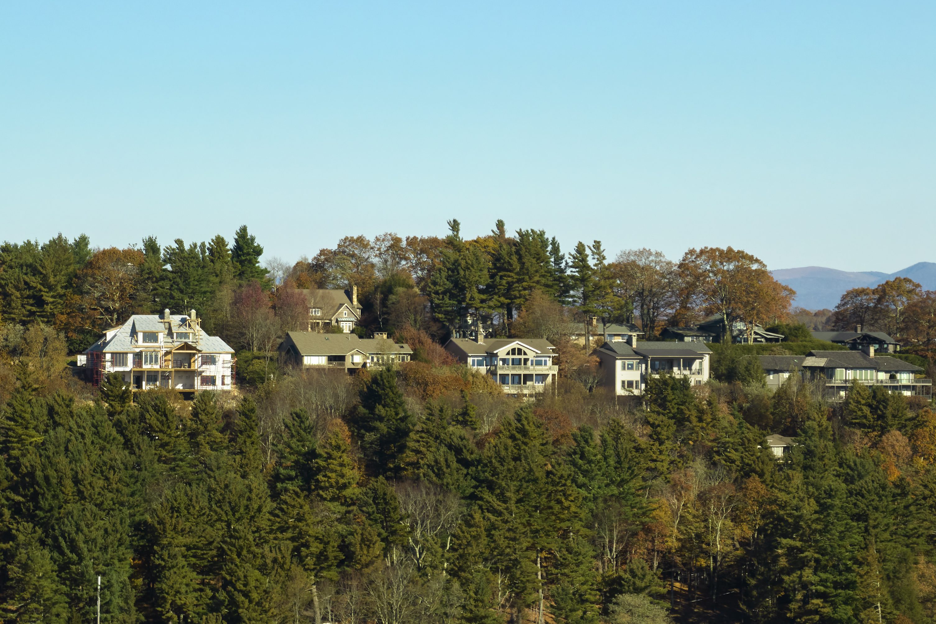 Houses on wooded hillside in autumn