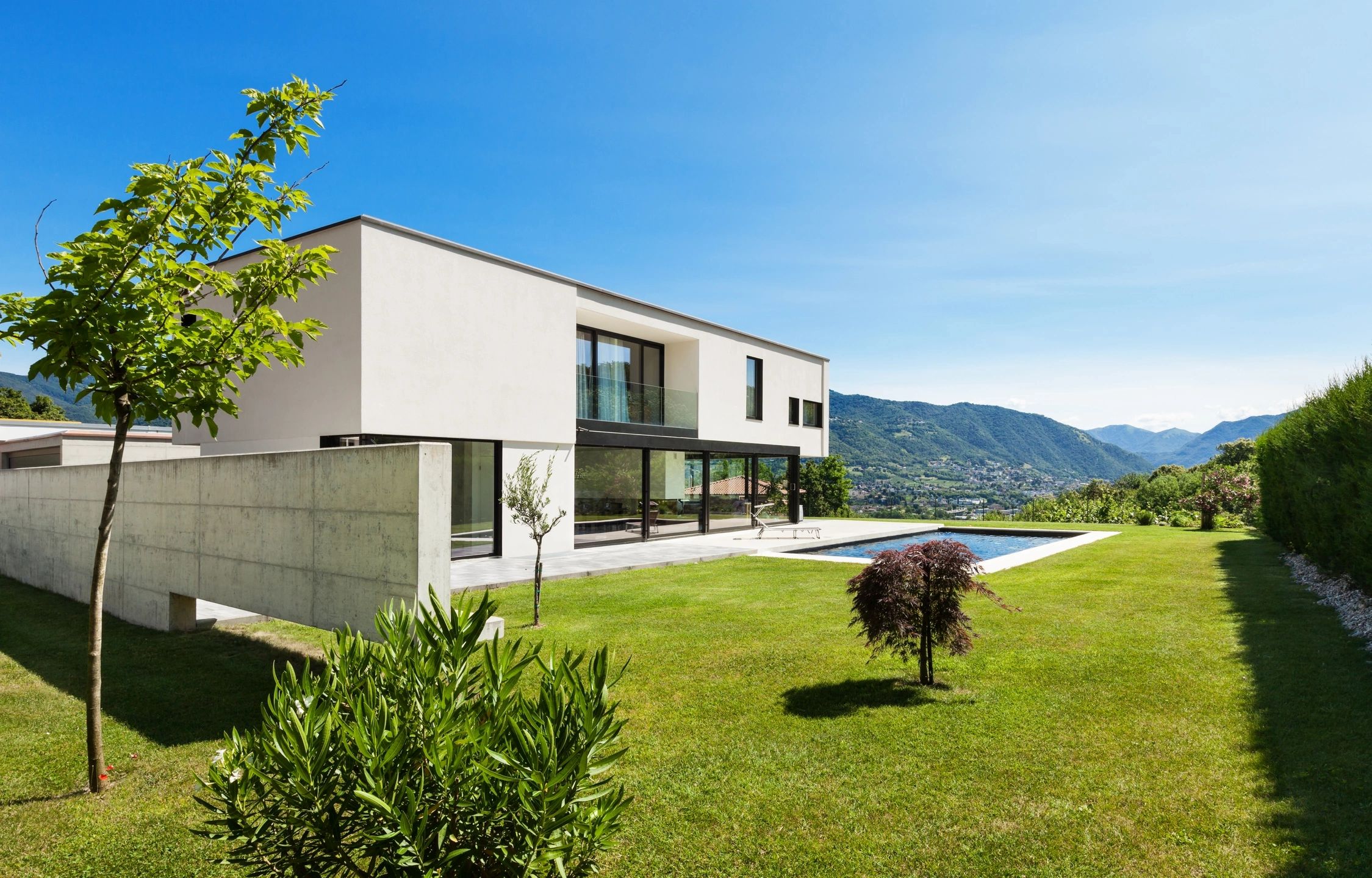 Modern white house with lawn and pool