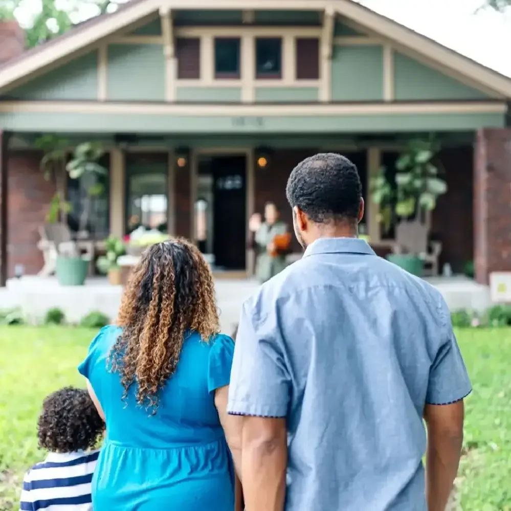 Family walking toward home with front porch